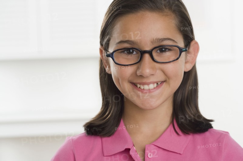 Hispanic girl wearing eyeglasses and smiling