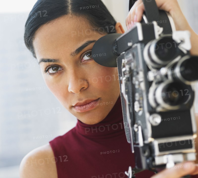 African woman using old fashioned film camera