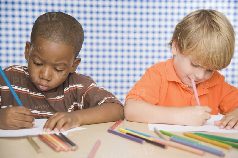 Two young boys coloring