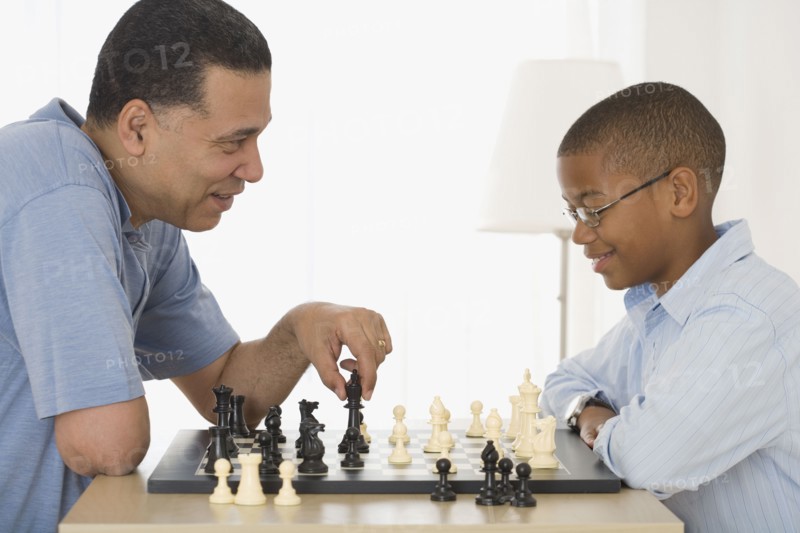 African father and son playing chess