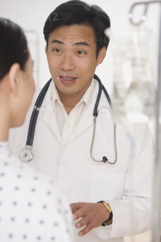 Asian male doctor talking to patient