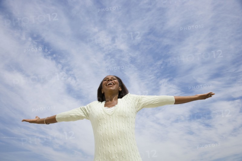 African American woman with arms outstretched