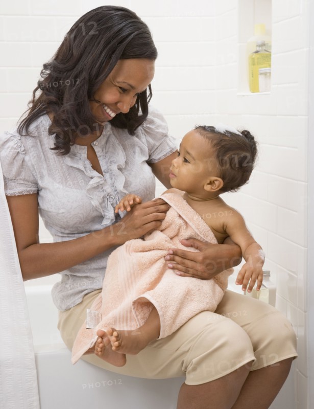 African American mother drying off baby