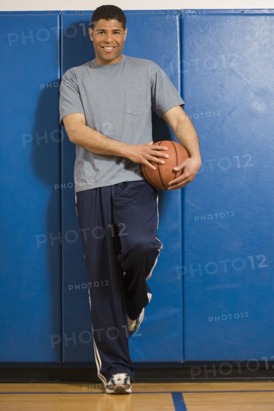 Hispanic man holding basketball