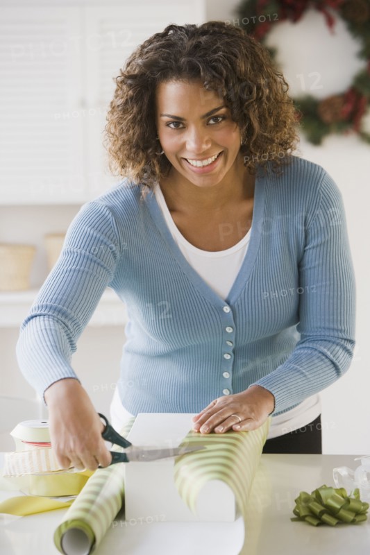 African woman wrapping gift