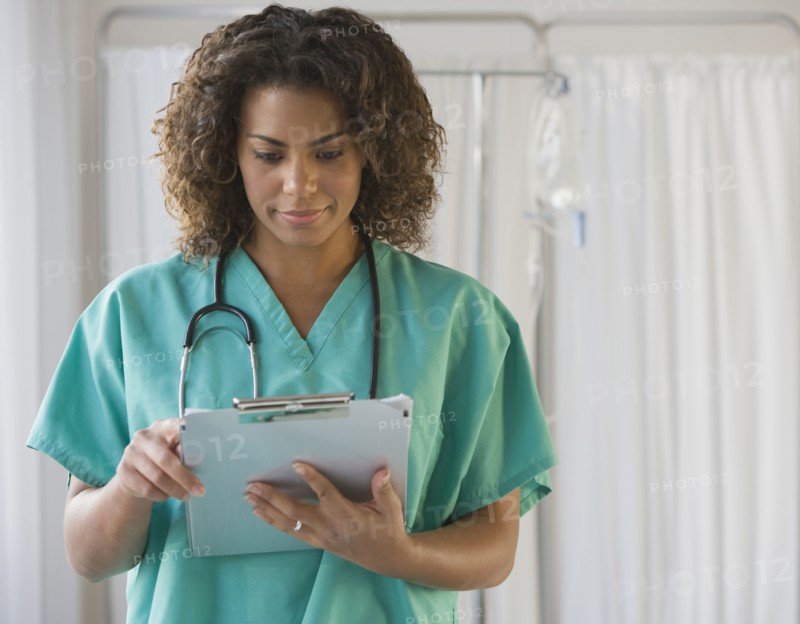 African female doctor looking at chart