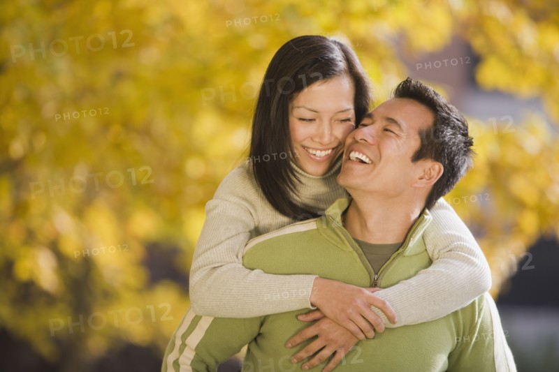 Asian woman hugging boyfriend