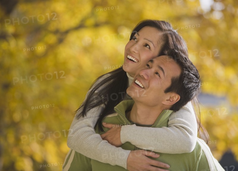 Asian woman hugging boyfriend