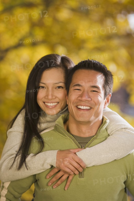 Asian woman hugging boyfriend