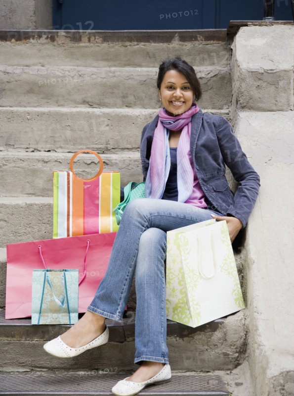 Mixed Race woman with shopping bags