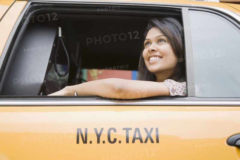 Mixed Race woman looking out taxi cab window