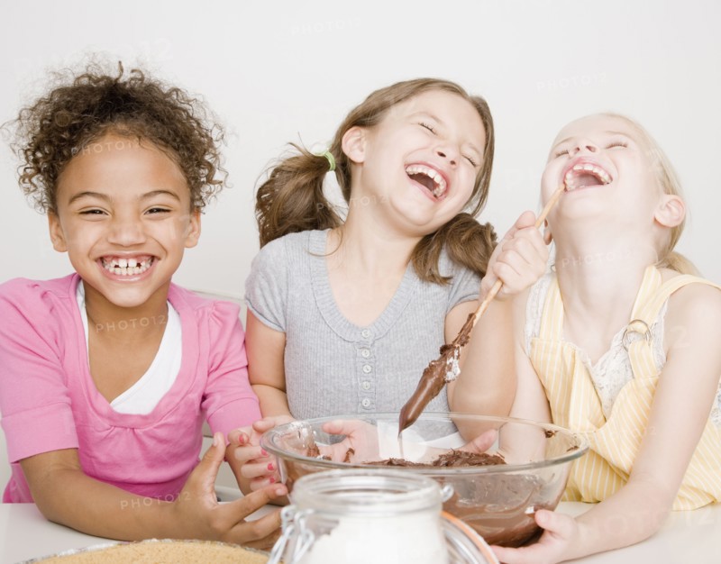 Multi-ethnic girls making batter