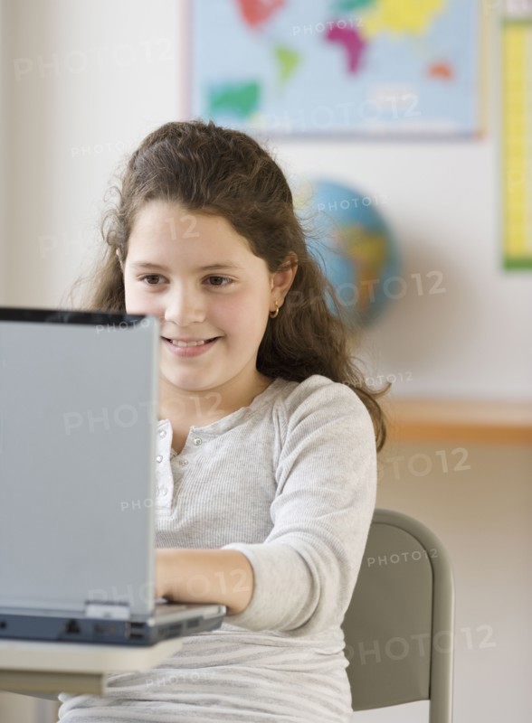 Hispanic girl looking at laptop