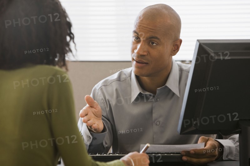 African businessman talking to co-worker