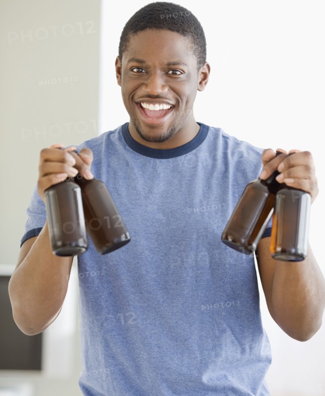 African man holding bottles of beer