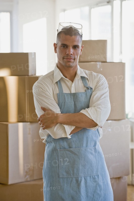 Hispanic man wearing apron and protective eyewear