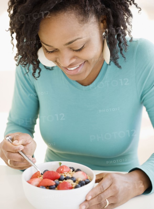 African woman eating cereal