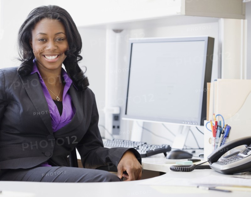 African businesswoman smiling in office