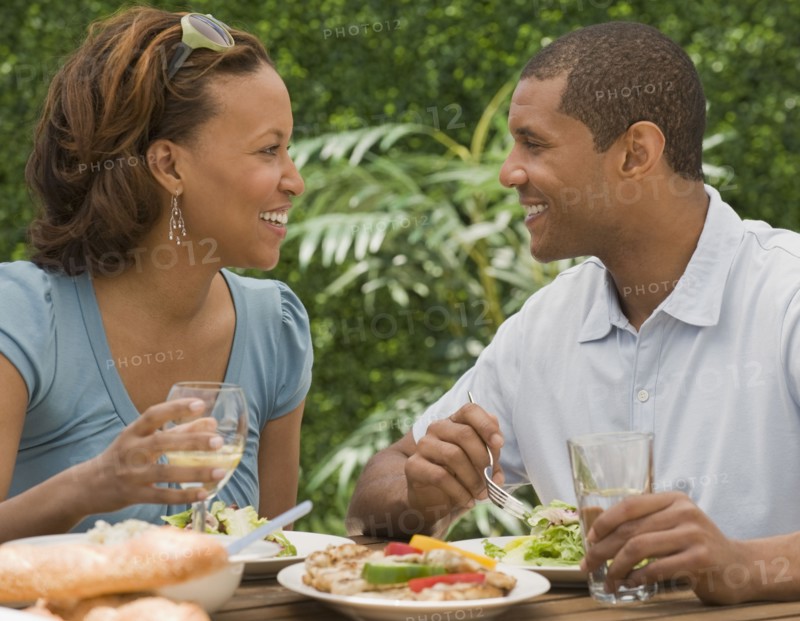 African couple eating on patio