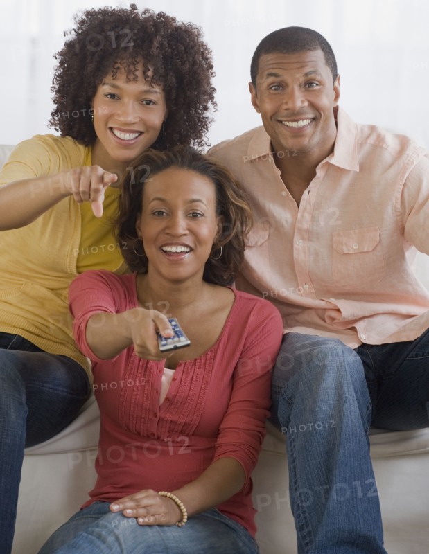 African man and women watching television