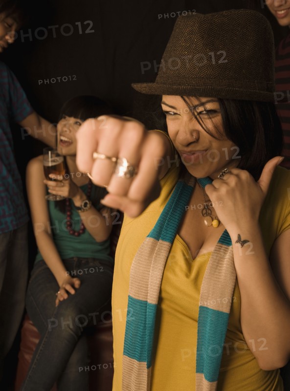 Mixed race woman punching air in nightclub