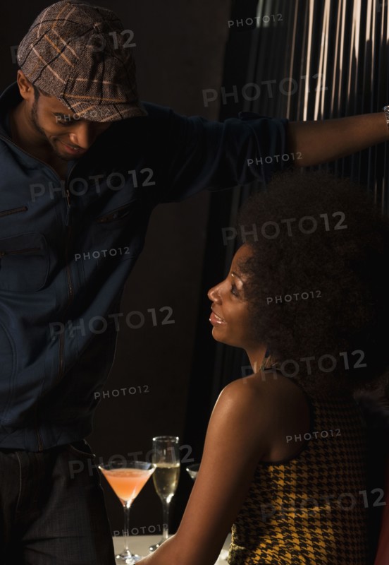 African couple drinking in nightclub