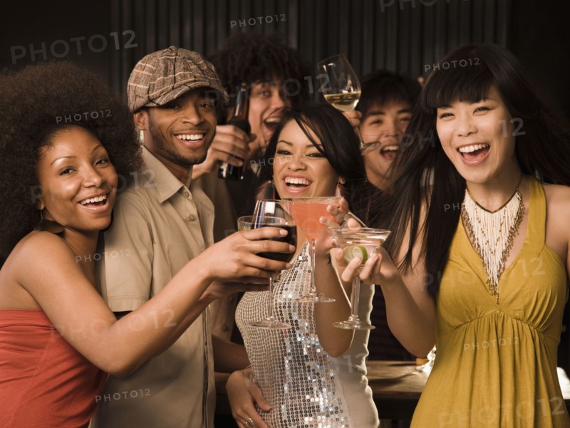 Multi-ethnic friends drinking in nightclub