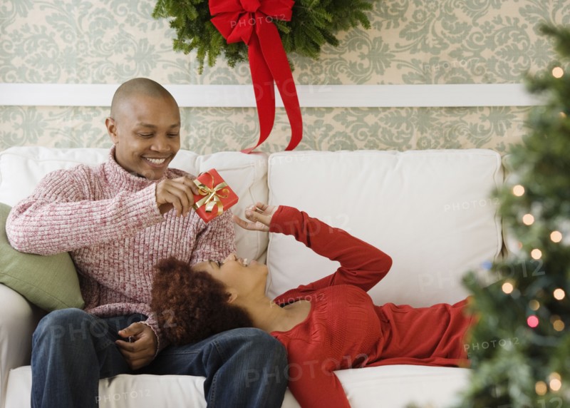 African man giving girlfriend Christmas present