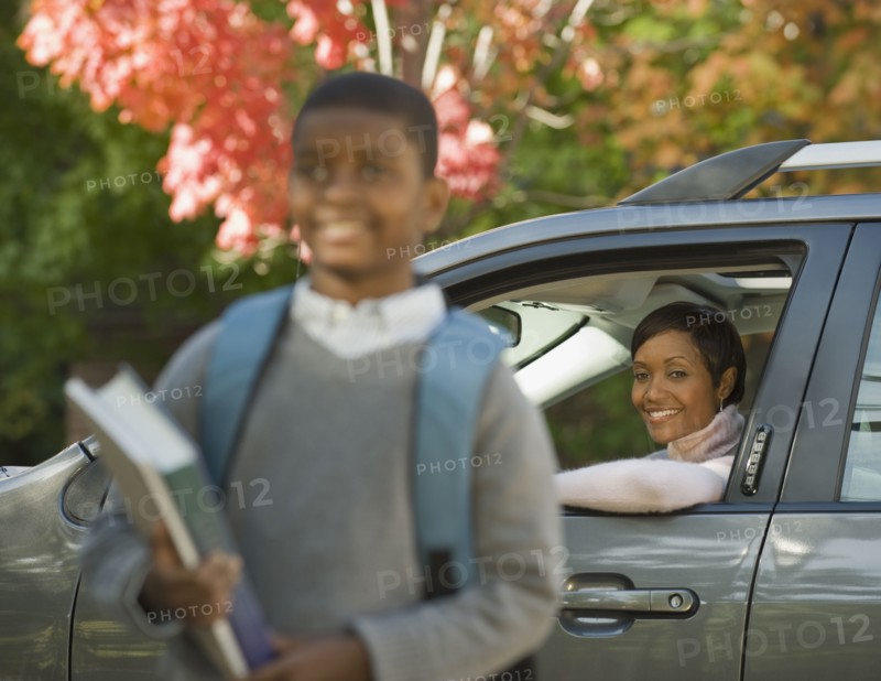 African mother dropping son off at school