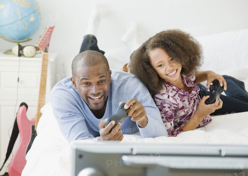 African father and daughter playing video game