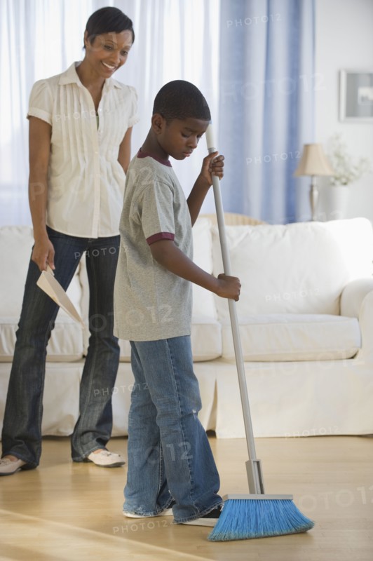 African mother and son doing housework together