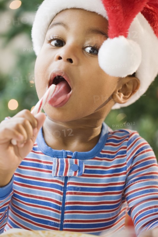 Close up of African American boy licking candy cane
