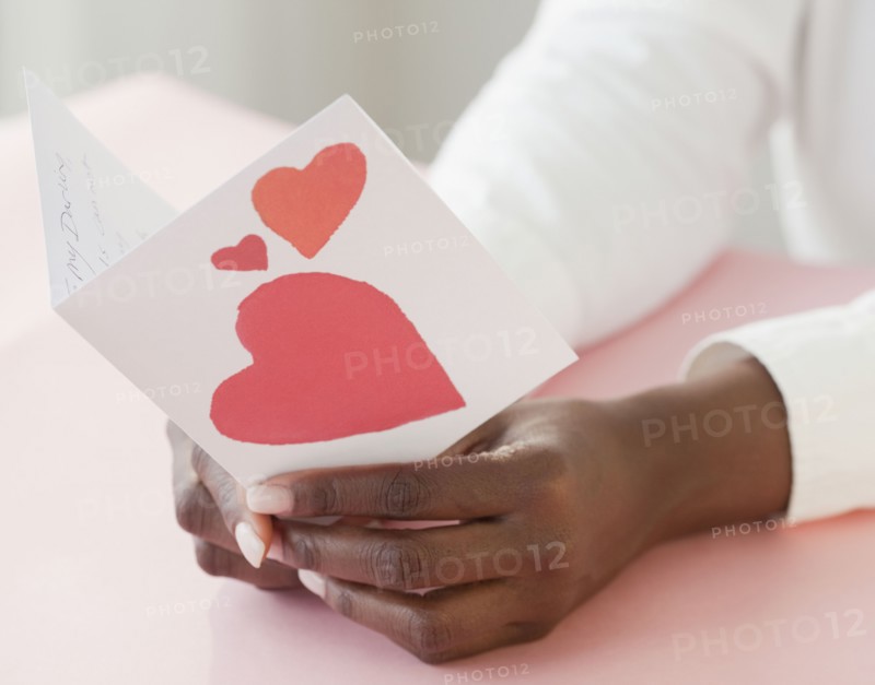 African woman holding Valentine's Day card