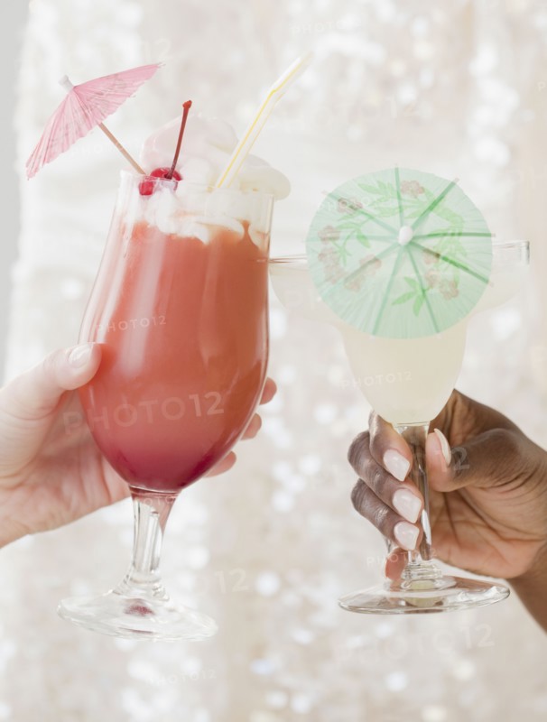 African and Caucasian woman drinking frozen cocktails