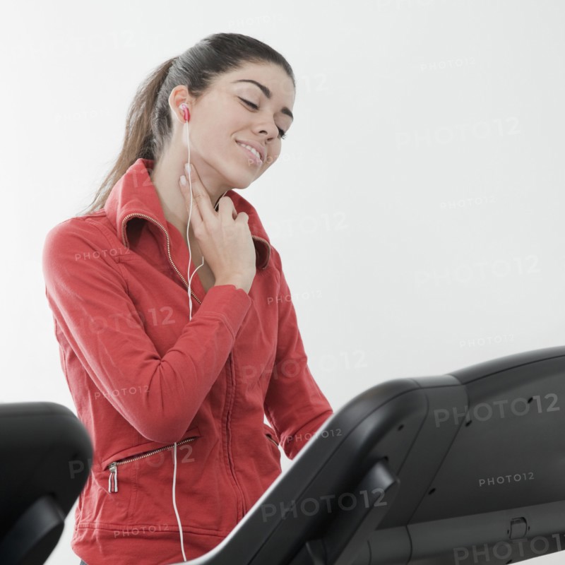 Hispanic woman checking pulse rate in health club