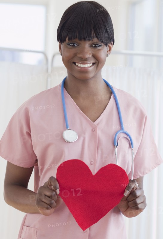 African nurse holding heart-shaped piece of paper