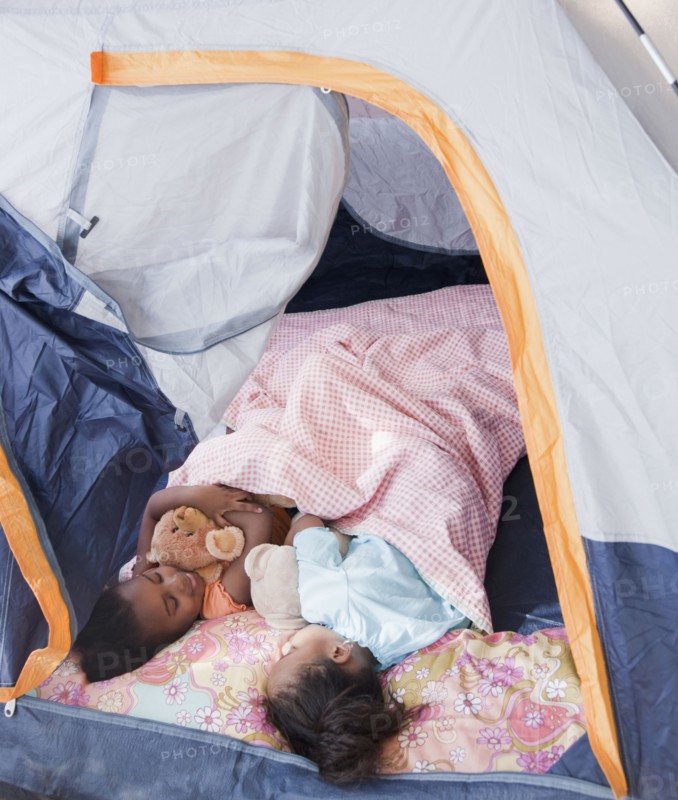 African girls sleeping in tent