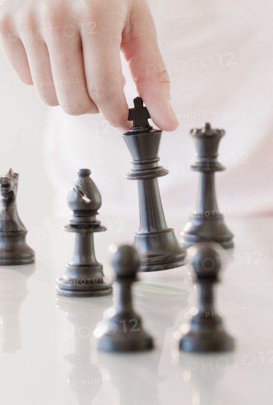 Woman moving chess piece