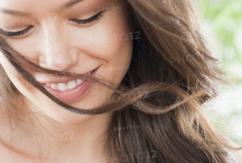 Mixed race woman looking down and smiling