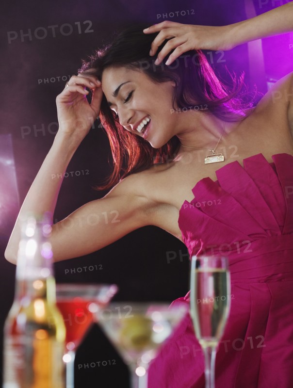 Hispanic woman dancing at nightclub