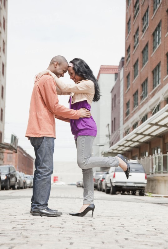 Couple standing face to face on urban street