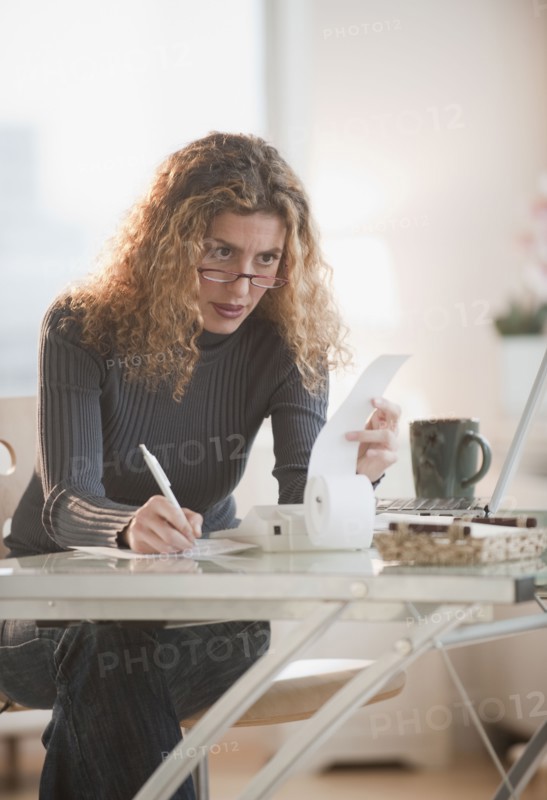 Hispanic woman paying bills