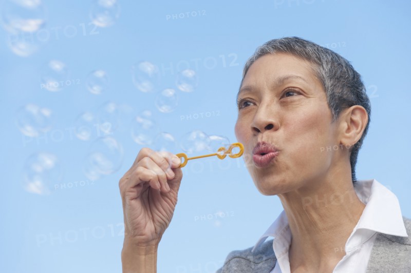 Chinese woman blowing bubbles