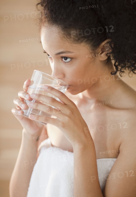 Mixed race woman drinking water