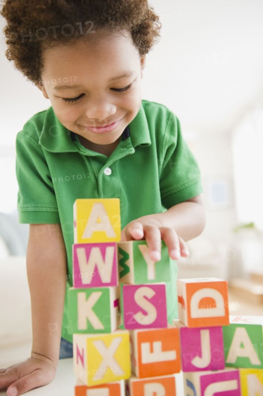 Black boy building with blocks