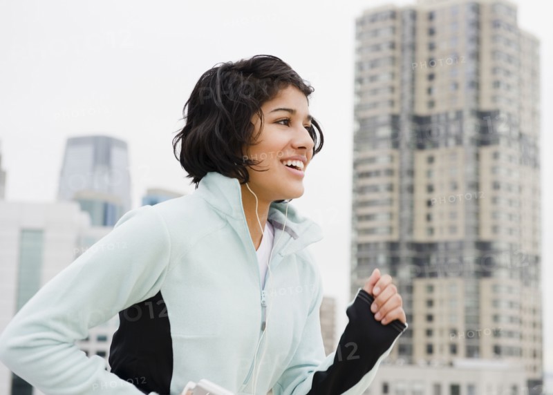 Hispanic woman running in city