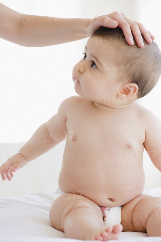 Mother comforting mixed race baby boy