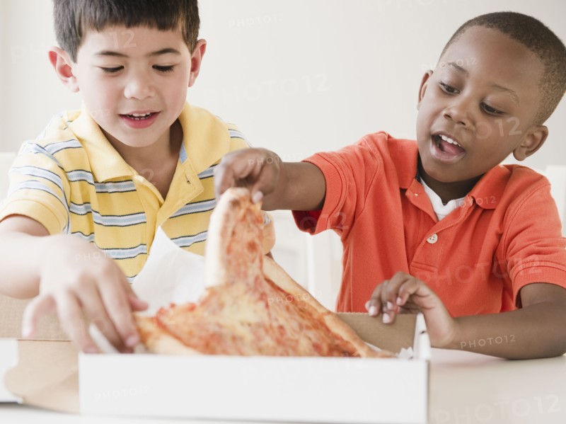 Boys eating pizza together