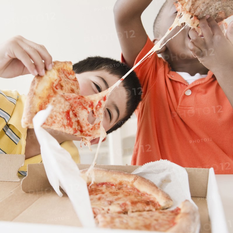 Boys eating pizza together