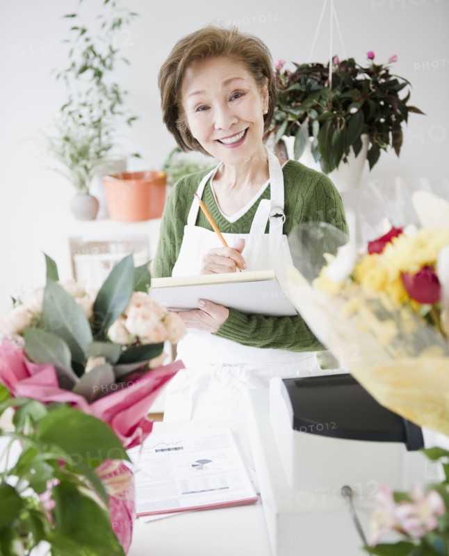 Japanese florist writing on notepad